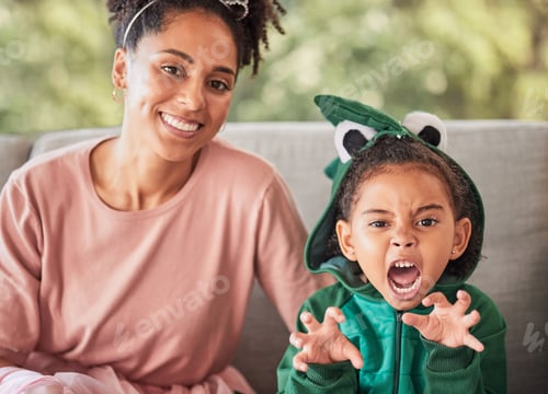 Preview: Portrait of mother and child playing, having fun with costume and bonding on a sofa at home. Fantas