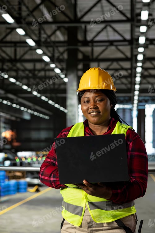 Preview: Portrait of staff in hard hat inspecting heavy equipment along production line