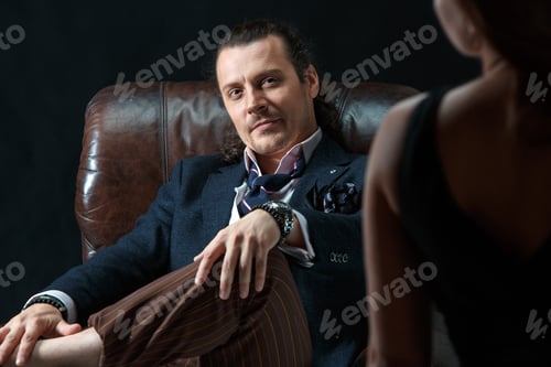 Preview: The Artist Or Mature Man Wearing Suit In A Classical Retro Fashion Style. The Woman Standing Near