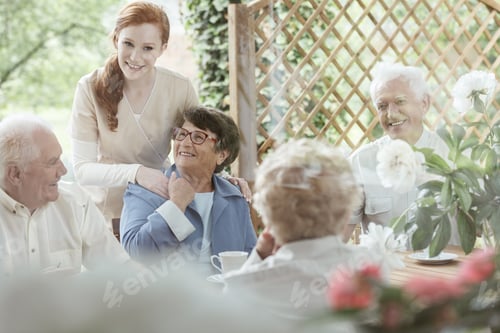 Preview: Friendly Caregiver with Senior People Outdoors