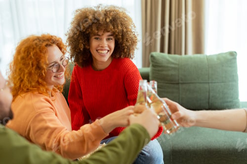 Preview: Friends celebrate together in a cozy living room, enjoying drinks and laughter on a sunny afternoon