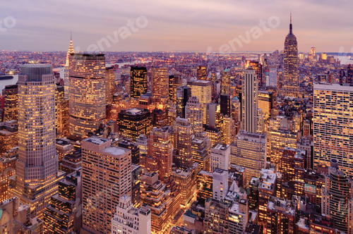Preview: Aerial view of highrise buildings in cityscape at twilight