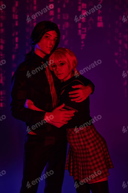 Preview: students in wigs and uniform embracing in red neon light on purple abstract backdrop, cosplayers