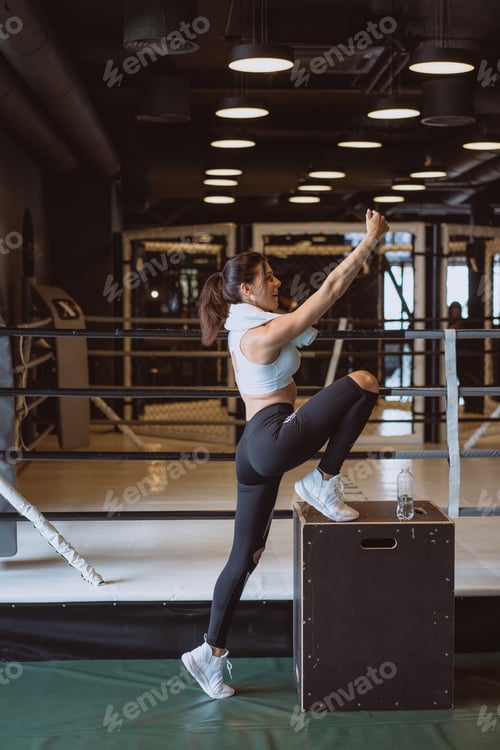 Preview: Young sporty woman taking a selfie with mobile phone for social networks at gym