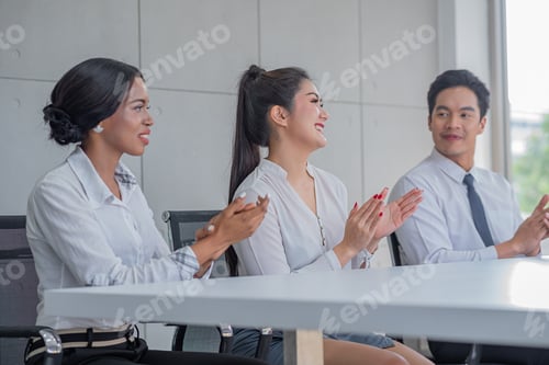 Preview: business people applauding in a meeting room or seminar