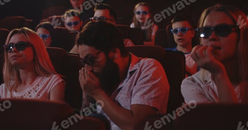 Preview: Medium Shot Of A Man Talking On His Cell Phone While Watching A Movie In A Cinema