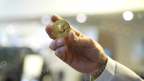 Preview: Businessman hand holding glowing bitcoin sign. Stock. Virtual money concept and Financial growth