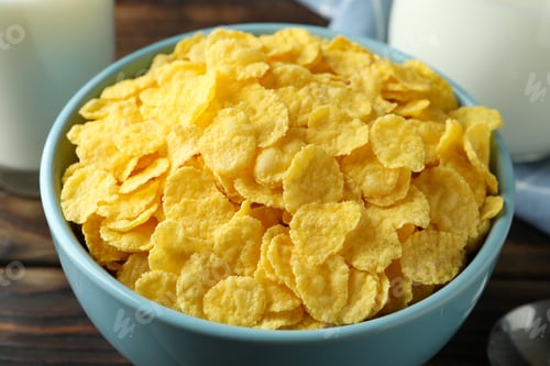 Preview: Concept of tasty breakfast with cornflakes on wooden table, close up
