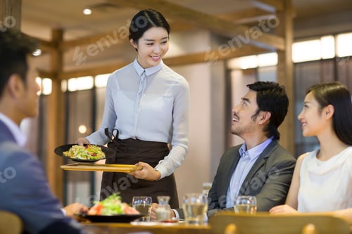 Preview: Waitress serving in restaurant