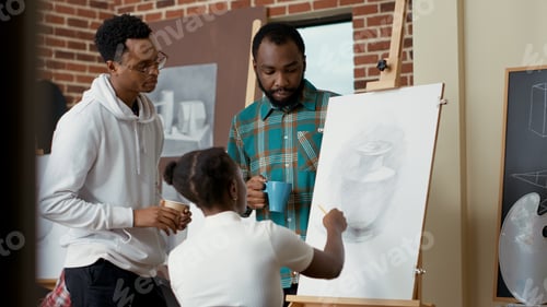 Preview: Team of art class students using pencil to draw vase model