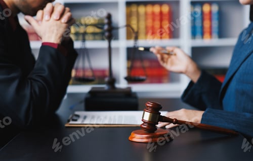 Preview: Lawyer working with client discussing contract papers with brass scale about legal legislation.