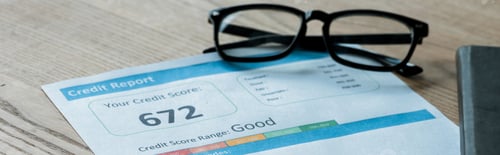 Preview: panoramic shot of glasses near document with credit report letters