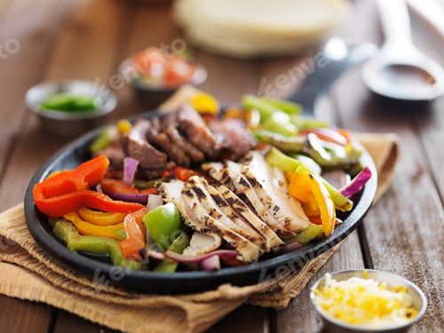 Preview: chicken and steak mexican fajitas in iron skillet
