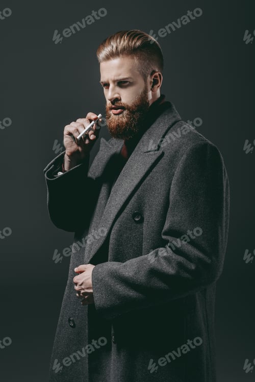 Preview: portrait of stylish man in jacket with cigarette isolated on black