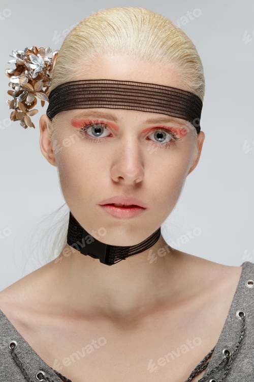 Preview: Portrait of calm girl with choker on her neck, pink make up and hair band