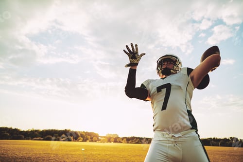 Preview: Football quarterback about to throw a pass during team practice