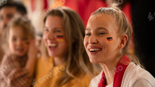 Preview: Excited football fans, supporting German national team in live soccer match at stadium.