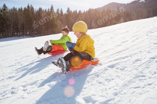 Preview: Children enjoy a fun sled ride down a snowy slope