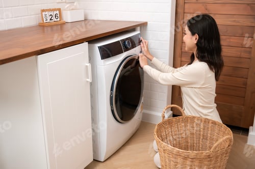 Preview: Young woman is doing laundry in home