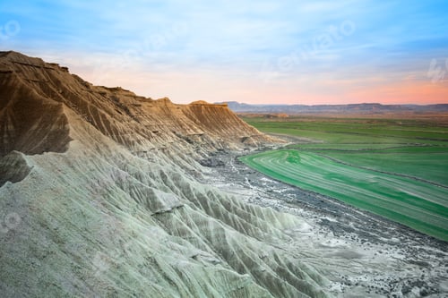Preview: Stone desert hills near green field