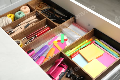 Preview: Stationery and sewing accessories in open desk drawer indoors, closeup