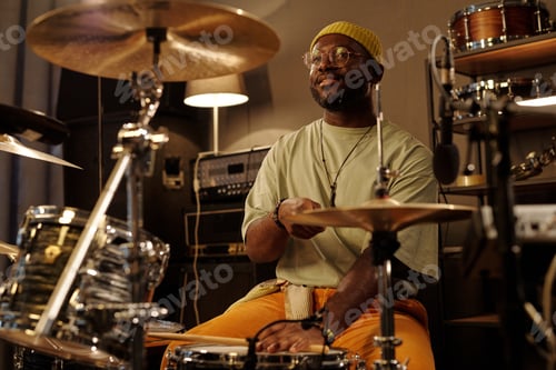 Preview: Playing Drum Kit in Cozy Studio with Warm Lighting