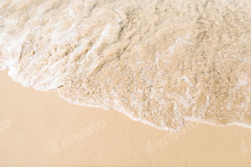 Preview: Background image of soft ocean wave on sandy beach.
