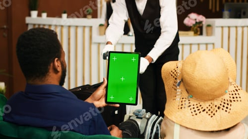Preview: Guests holding tablet with greenscreen