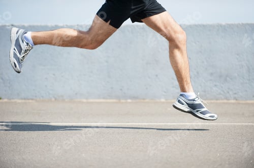 Preview: Burning the miles away. Side view close-up image of man running outdoors