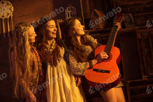 Preview: Three gorgeous women in boho style having fun and playing guitar