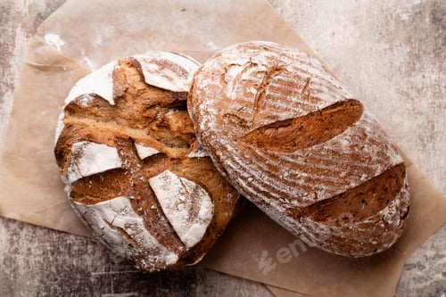 Preview: Assortment of baked bread on wooden table background.