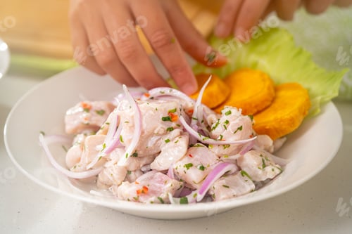 Preview: Chef garnishing delicious peruvian ceviche with cilantro and onion