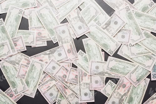 Preview: top view of scattered dollar banknotes on grey background