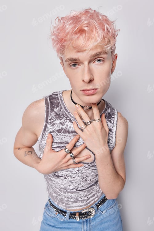Preview: Serious self confident transgender guy with pink hair dressed in fashionable clothes focused