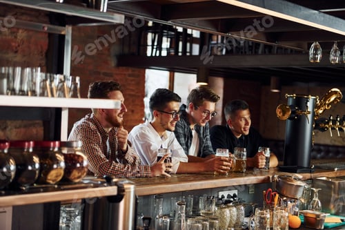 Preview: Football fans. People in casual clothes sitting in the pub