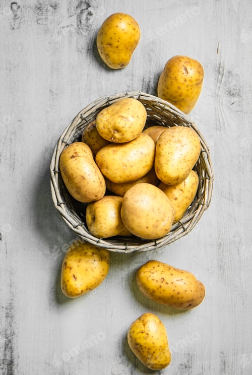 Preview: Fresh potatoes. On white table.
