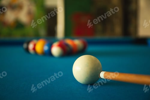 Preview: A cue is poised to strike the ball on a blue table