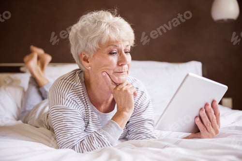 Preview: Senior Woman Relaxing with a Tablet at Home