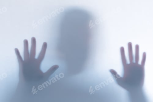 Preview: Defocused scary ghost silhouette behind a white glass background