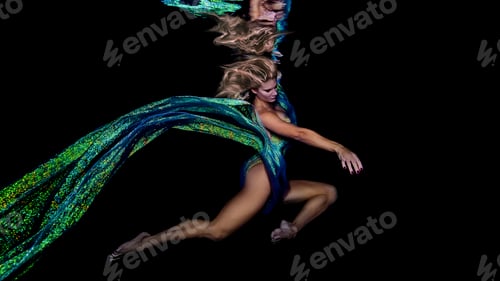 Preview: Underwater view of woman draped in colourful fabric