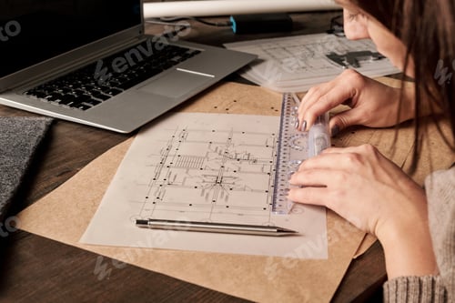 Preview: Hands of contemporary female engineer or architect with ruler making sketch
