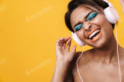 Preview: Image of shirtless african american woman singing and using headphones