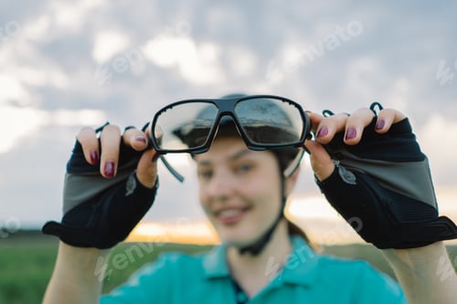 Preview: Woman Wearing Cycling Glasses and Helmet in Field