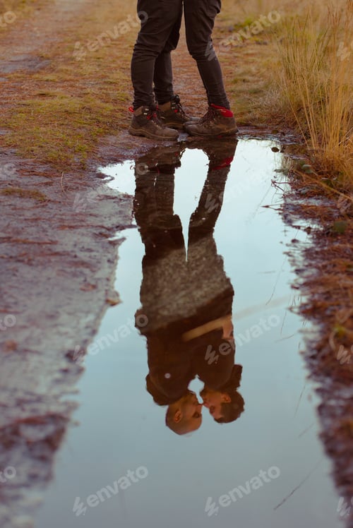 Preview: Men hugging and kissing near water puddle