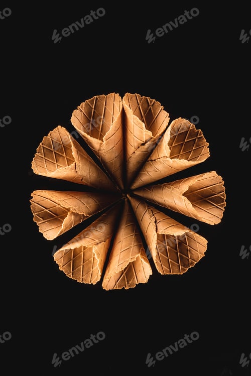 Preview: top view of circle of edible ice cream cones isolated on black