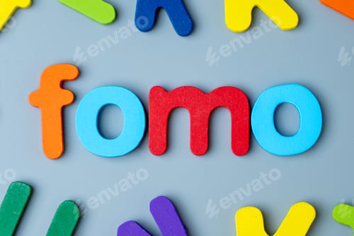 Preview: Colorful wooden alphabet letters arranged to form the word FOMO.