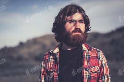 Preview: Handsome Bearded Young Man Standing Staring Into The Sunset With A Dreamy Pensive Expression, Head
