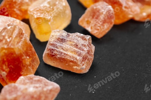 Preview: brown sugar rock organic crystalline close up on dark background