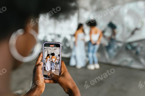 Preview: Person recording video of friends dancing in the street