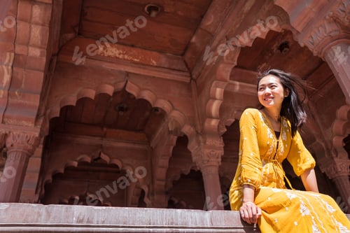 Preview: Ethnic traveler sitting in old arch